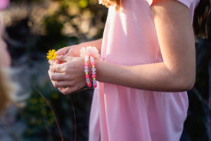 Girl holding a flower on the beach in Ocean City New Jersey