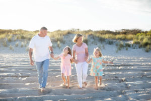 Family walking on the beach at sunset in Ocean City New Jersey