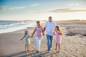 Family walking on the beach at sunset in Ocean City New Jersey