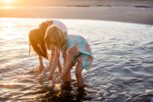 Young sisters playing in the ocean in Ocean City New Jersey